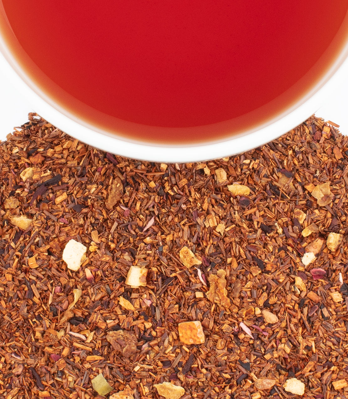 "African Autumn tea sachets with a cup of brewed tea and loose leaf blend featuring rooibos and fruit pieces.