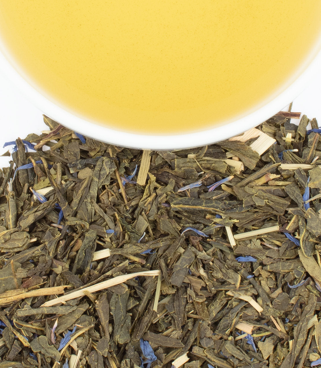 Blueberry Green tea sachets in a tin, with loose tea leaves and a cup of brewed tea above.