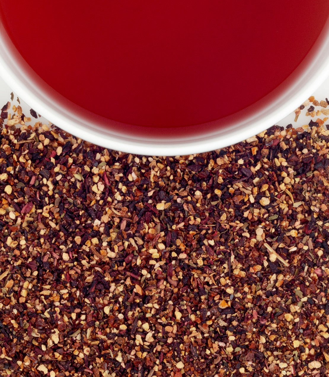 Raspberry Herbal tea sachets with vibrant red brew and loose herbal blend displayed below.