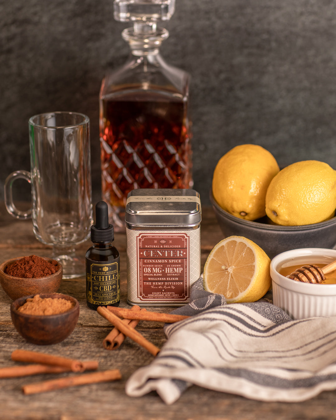 Center 8 CT Cinnamon Spice sachets with hemp, honey, lemons, and spices on a rustic wooden table.