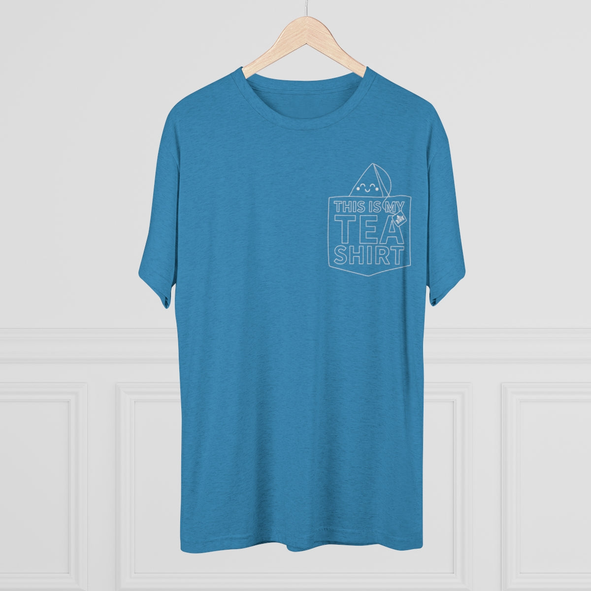 Blue graphic tee featuring the phrase "This Is My Tea Shirt" in a playful design on the front pocket area.